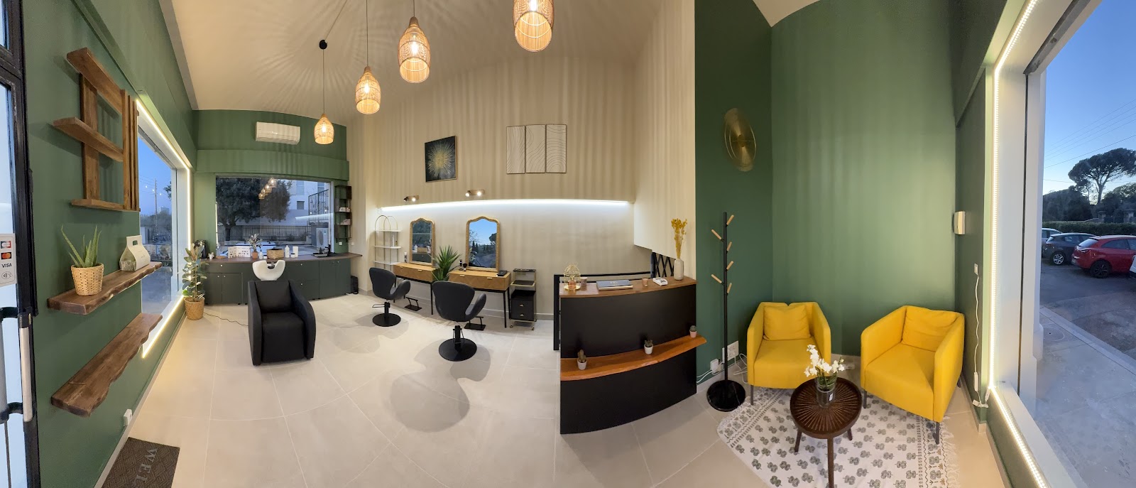 Salon interior with green walls, yellow chairs and a reception desk