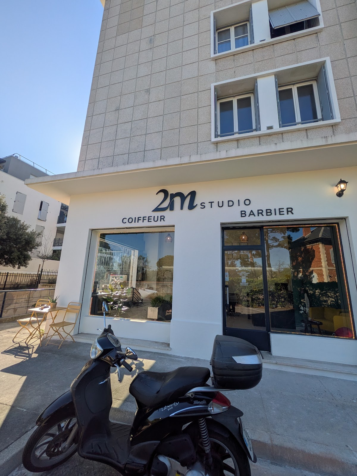 Daytime storefront exterior under a clear blue sky