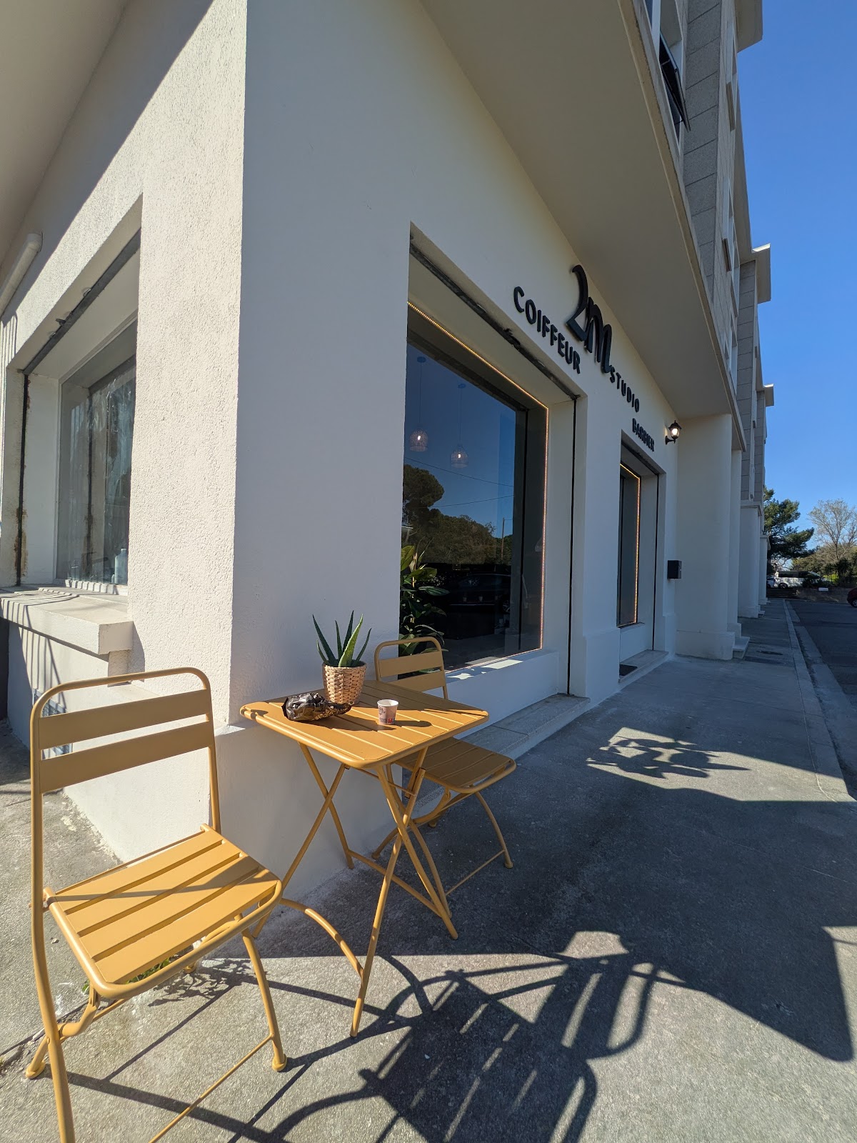 Daytime view of the storefront patio with chairs and tables