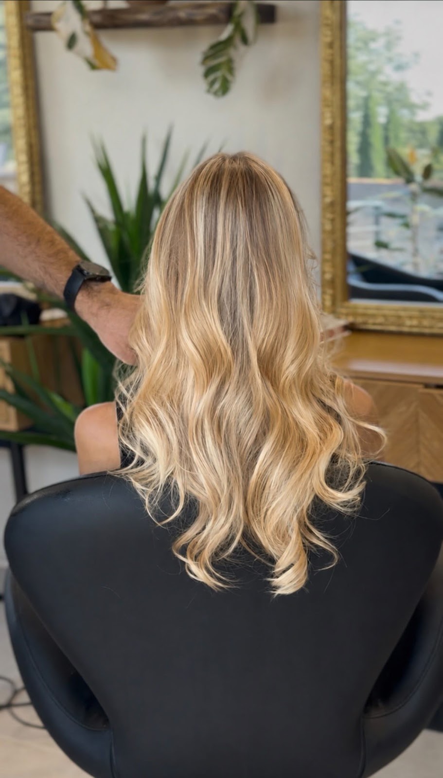 Long wavy blonde hair, styled and adjusted by hand