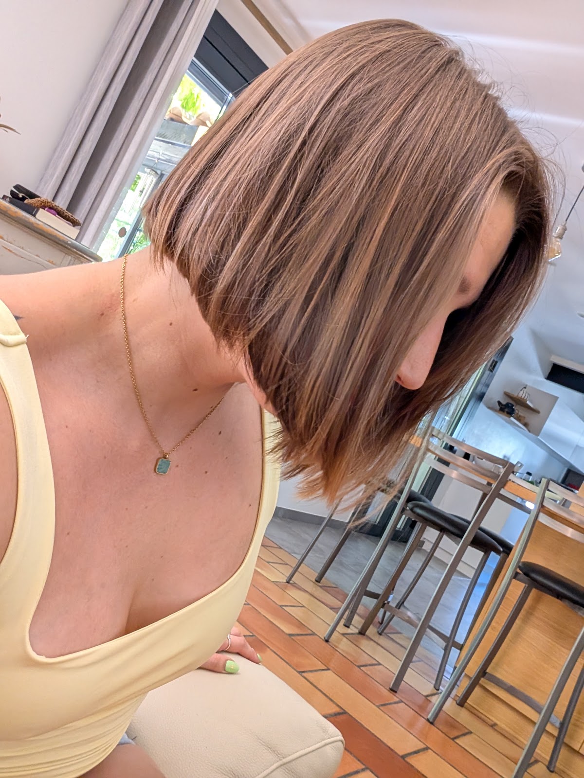 Medium-length layered brown hair shown in side profile