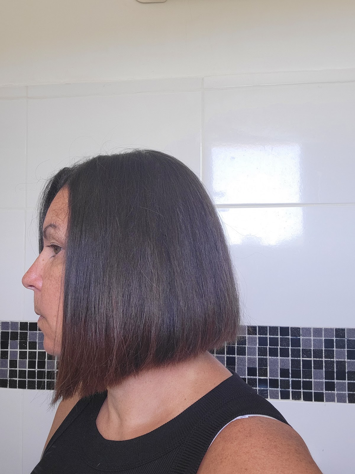 Medium-length burgundy wavy hair shown from behind