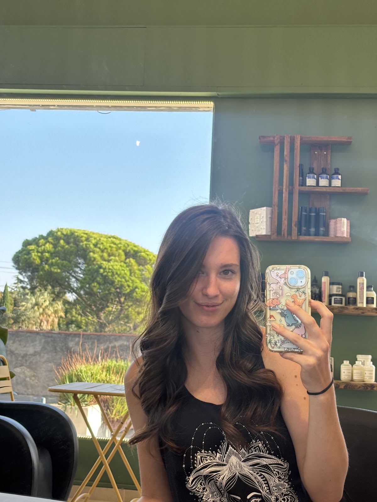 Client with dark wavy hair at the salon reception
